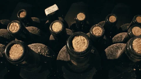 Tracking Close Shot of Old Aged Stacked Wine Bottles in a Cellar Stock Footage 254821868
