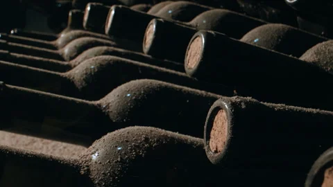 Tracking Close Shot of Old Aged Stacked Wine Bottles in a Cellar Video stock 254821894