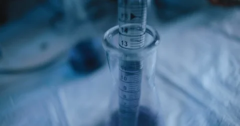 Tracking close up shot of purple liquid being taken out from a conical flask. Stock Footage 121097537