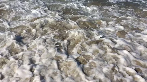 Tracking Close Up of Water Rushing Beach Stock Footage 115008020