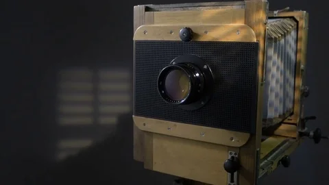 Tracking close up zoom out shot of old vintage wooden photo camera lighting by 스톡 동영상 75895267