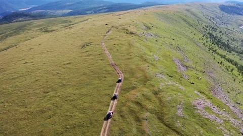 Tracking a column of ATVs from above Stock Footage 163497458