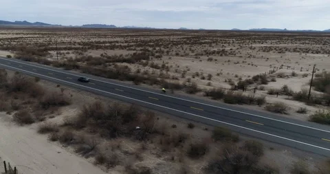 Tracking a cyclist on long straight road in Salome, Arizona drone aerial 4K Video stock 111310659