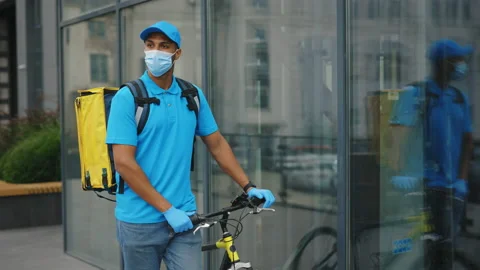Tracking Delivery Man Courier Wearing Medical Going Near the Business Centre Stock Footage 238909785