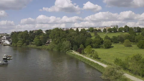 Tracking down a river to boom up over a leafy countryside hillside. Stock-Footage 151161034