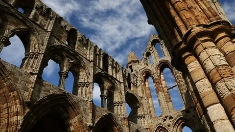 Tracking Into Dramatic Old Ruined English Abbey Low Angle Against Blue Sky 스톡 동영상 125191453
