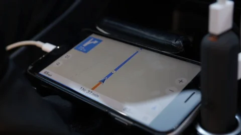 Tracking a drive on a mobile phone GPS device in a car Stock Footage 129290842