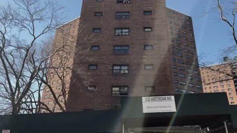 Tracking driving red brick buildings housing projects 125th street Amsterdam Ave Stock Footage 149539485
