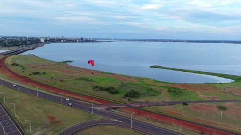 Tracking drone fly around a powered paragliding at Balneario Costa Sur Vídeo Stock 328521285
