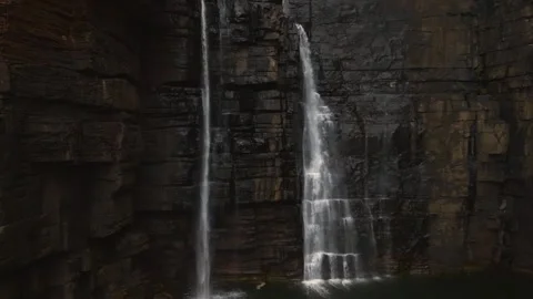 Tracking drone shot up and over beautiful kimberley waterfall in Australia Stock Footage 307609336