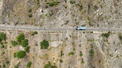 Tracking Drone shot of freight lorries and fuel tanker on narrow mountain p.. Stock Footage 337615260