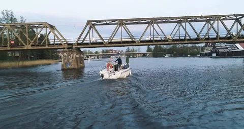 Tracking drone shot of sailboat under the bridge Stock Footage 89416095