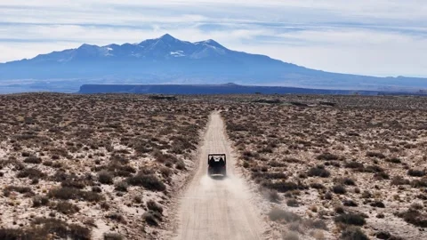Tracking Drone Shot of UTV Vehicle on Dusty Road in Utah Desert USA Stock Footage 320105024