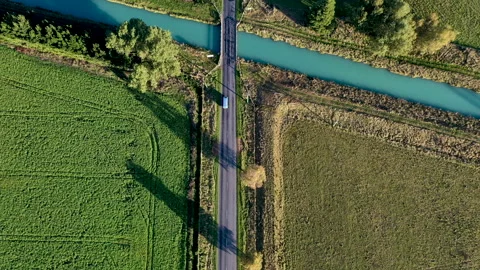 Tracking drone shot of van over bridge in New Zealand country Stock Footage 134536229