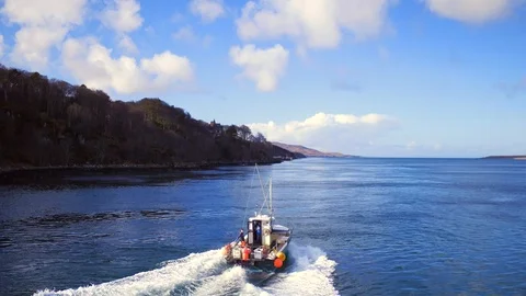 Tracking / dynamic incoming drone shot of a creel fishing boat. 4K Stock Footage 93456674