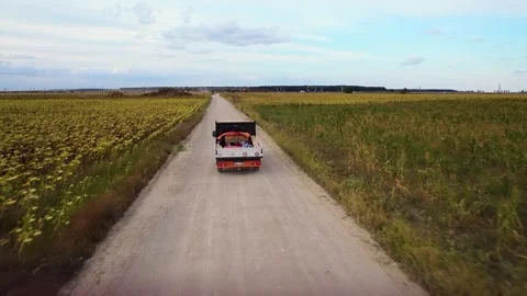 Tracking a flatbed on a dirt road Stock Footage 248720058