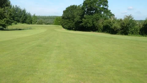 Tracking forward down a fairway towards a golf ball 動画素材 288011794