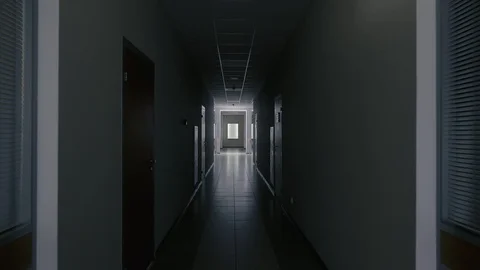 Tracking inside a long dark gloomy corridor of abandoned business center with Stock Footage 121454901