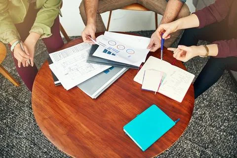 Tracking the latest business progress reports. High angle shot of people looking Stock Photos