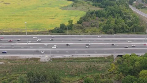 Tracking to the left of highway with traffic field in foreground. Stock Footage 250489772