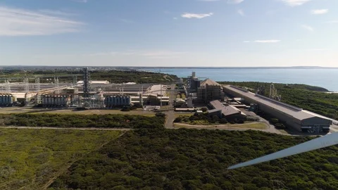 Tracking left to right revealing wind tower and aluminum smelter in background. Stock Footage 88304002