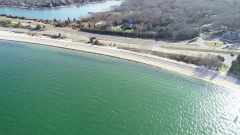 Tracking left on shore and road of sag harbor Stock Footage 155466365