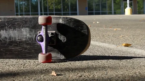 Tracking Left Skateboard on its Side in Parking Lot Extreme Sports Dolly Shot Stock Footage 114033941