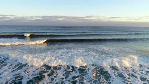 Tracking left on waves washing up to shore Stock Footage 155464224