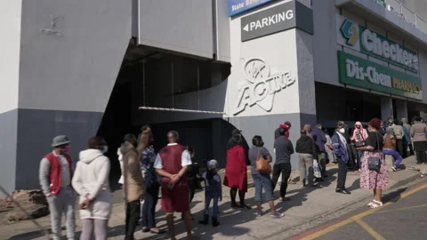 Tracking of a long queue of people waiting to stock up on groceries. Stock Footage 170943306