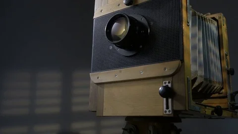 Tracking low angle zoom out shot of old vintage wooden photo camera lighting by Stock Footage 75891280