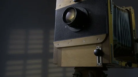 Tracking low angle zoom out shot of old vintage wooden photo camera lighting by 動画素材 75892866