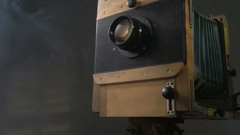 Tracking low angle zoom out shot of old vintage wooden photo camera lighting by 動画素材 75893706