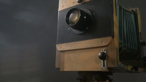 Tracking low angle zoom out shot of old vintage wooden photo camera lighting by Stock Footage 75894617