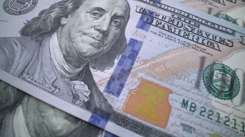 Tracking macro of Benjamine Franklin's face on the US one hundreed dollar bill Stock Footage 107608640