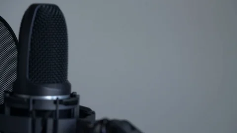 Tracking macro shot of Cute little blonde girl with headphones singing with a Stock Footage
