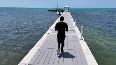 Tracking a man on a dock Stock Footage 315515410