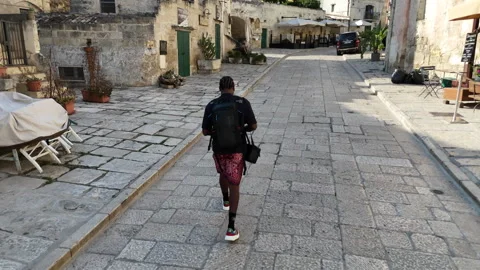 Tracking man through city Stock Footage 316771356