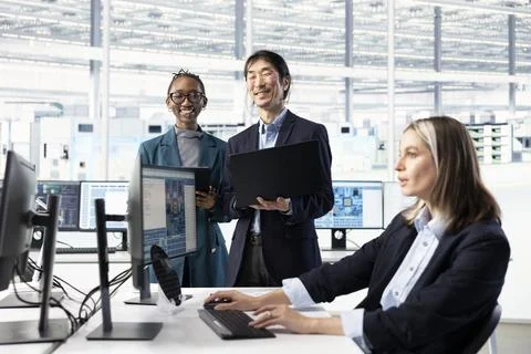 Tracking microchip defects data, PC and multiethnic engineering team Stock Photos