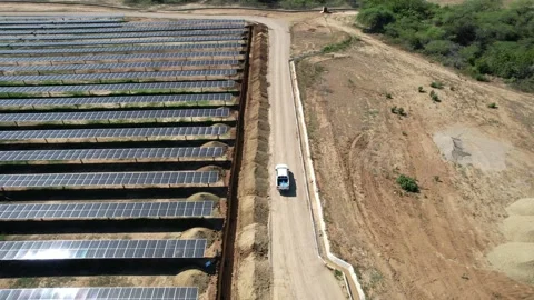 Tracking mode of a pick up in a solar farm Stock Footage 234955789
