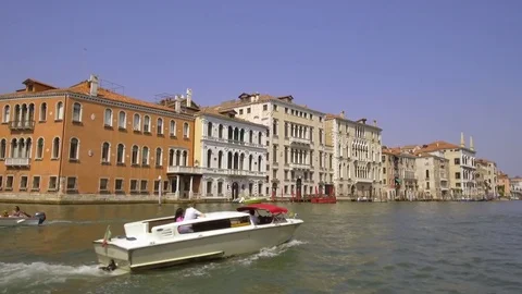 Tracking moving shot along the central Grand Canal passing a Gondola below th Stock Footage 83348810