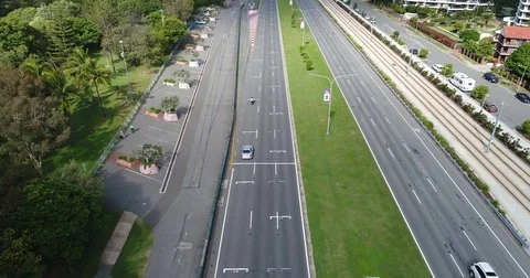 Tracking moving traffic by drone revealing the beach and Surfers Paradise Stock Footage 76234986