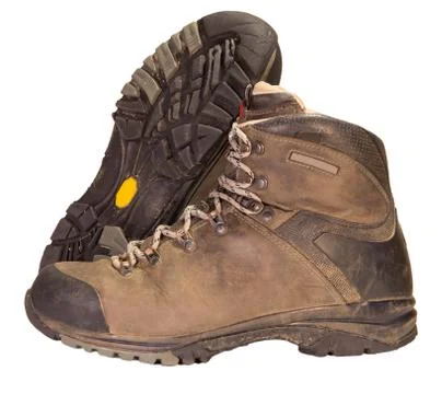Tracking the old brown leather boots. Stock Photos