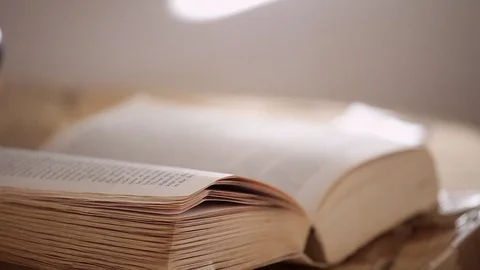 Tracking out from old paperback book and analogue telephone Stock Footage 124937767