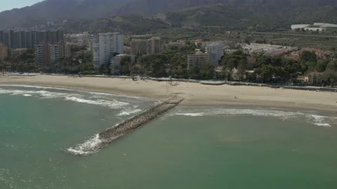 Tracking over sea to overview of beachfront apartments and then back to Seaview 스톡 동영상 150405508