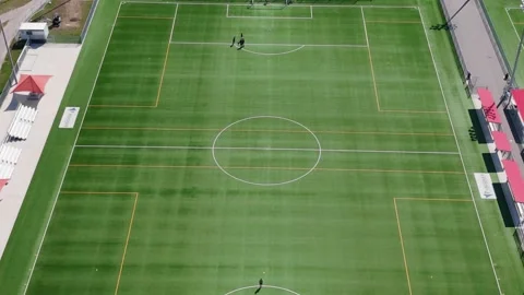 Tracking over soccer pitch while a few people practice Stock Footage 250422420