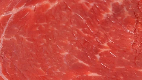 Tracking over uncooked angus beef steak, low angle. Meat texture. Dolly shot Stock Footage 121228270