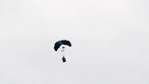 Tracking A Parachutist Jumpsuit Pilot Deploying A Parachute Against A Bright Stock Footage 196900921