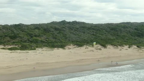Tracking a paraglider with a drone at the beach Stock Footage 168365256