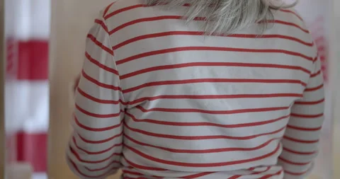 Tracking past the backs of voters at election booths, US flag behind Stock Footage 275539963