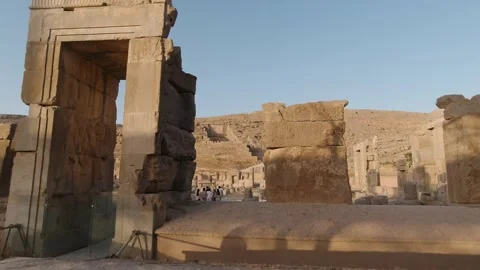 Tracking past fallen column drums at Persepolis ruins, golden light. Stock Footage 320460657
